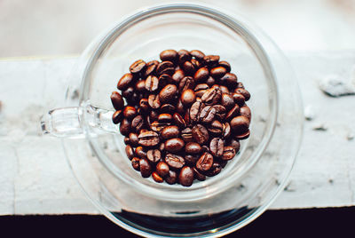 High angle view of coffee beans in glass on table