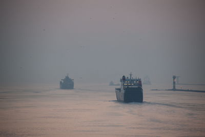 Scenic view of cruise ships in sea at distance