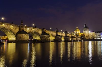 Illuminated buildings against sky at night