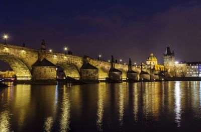 Illuminated buildings against sky at night