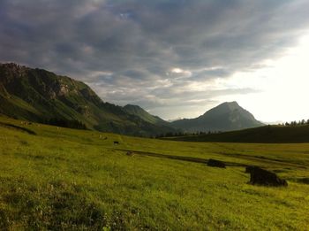 Scenic view of landscape against cloudy sky