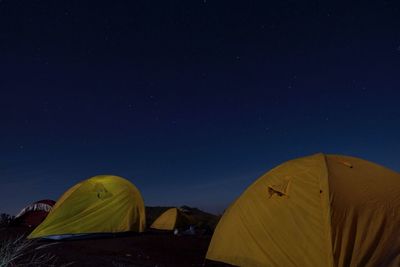 Tent against blue sky at night