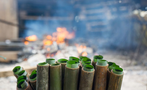 Close-up of burning candles on table