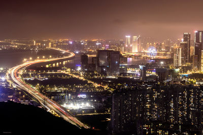 High angle view of illuminated buildings in city at night in shenzhen from the top of the mountain 