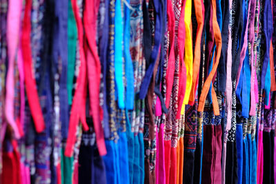Multi colored flags hanging in store for sale at market stall