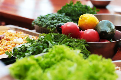 Fresh vegetables tomatoes, avocados, greens on the table, cooking process