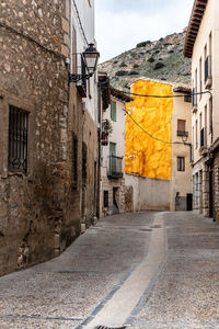 Street amidst buildings against sky