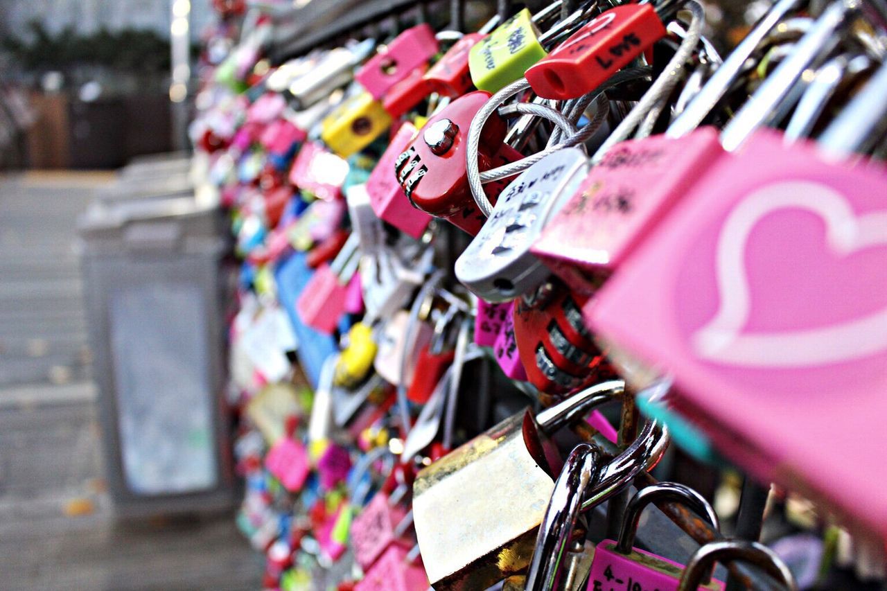 padlock, focus on foreground, close-up, multi colored, lock, metal, variation, selective focus, hanging, large group of objects, abundance, text, luck, security, love, communication, no people, day, choice, in a row