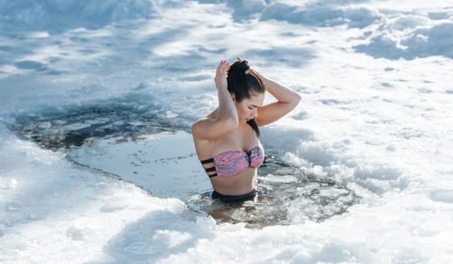 Rear view of woman in water