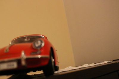 Close-up of toy car against wall