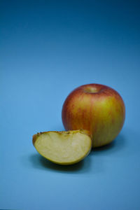 Close-up of apple against blue background