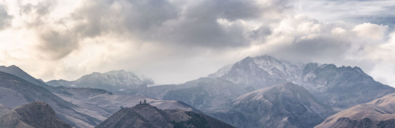 Scenic view of mountains against cloudy sky