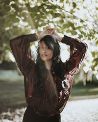 Portrait of young woman standing outdoors