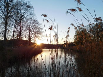 Scenic view of lake against sky at sunset