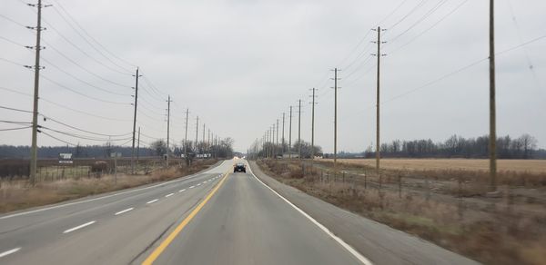 Cars on road against sky