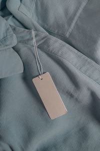 High angle view of paper hanging on bed