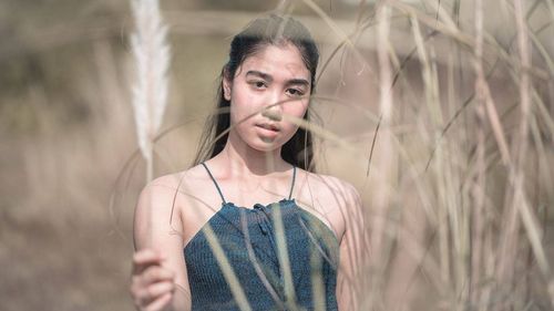 Portrait of a young woman standing outdoors