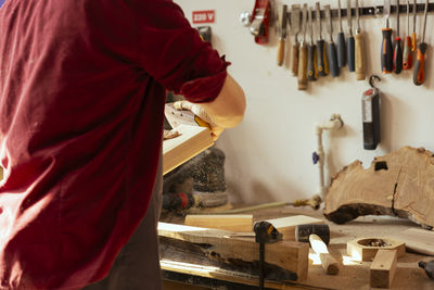 Midsection of man working at workshop