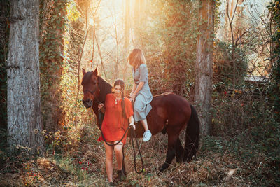 Women with horse in forest