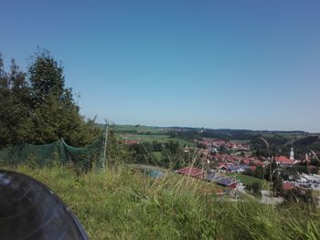 Scenic view of field against clear blue sky