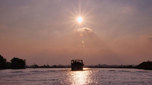 Scenic view of river against sky during sunset