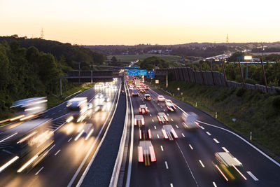 High angle view of light trails on highway at sunset