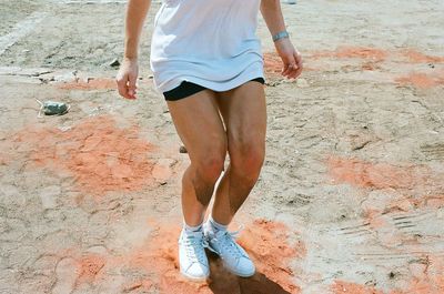 Low section of woman standing on tiled floor