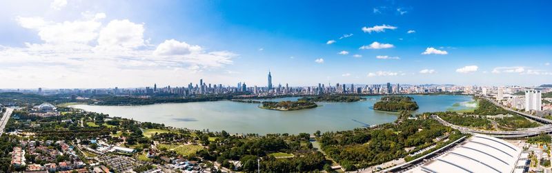 High angle view of city by river against sky