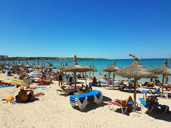 Scenic view of beach against clear blue sky