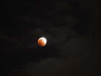 Low angle view of moon against sky at night