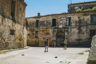 People walking on old building