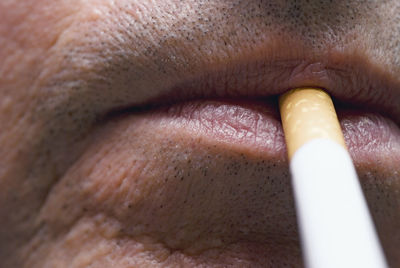 Cropped image of man smoking cigarette