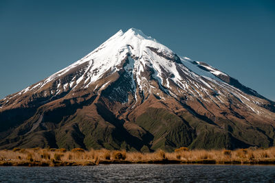 Scenic view of snowcapped mountains against clear sky