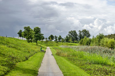 Footpath in park under a dramatic sky