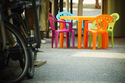 Empty chairs on street in city