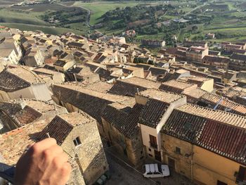 High angle view of person and buildings in old italian city, tiled roofs 