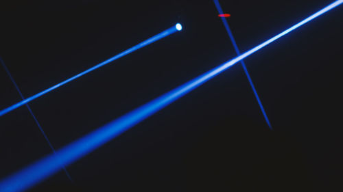 Close-up of illuminated lighting equipment against black background