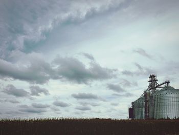 Scenic view of field against cloudy sky