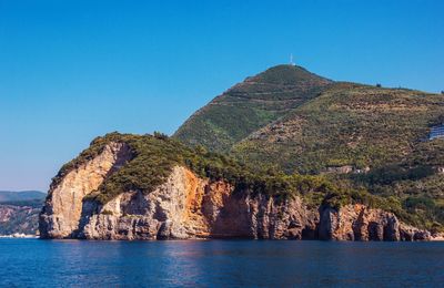 Panoramic view of sea against clear blue sky
