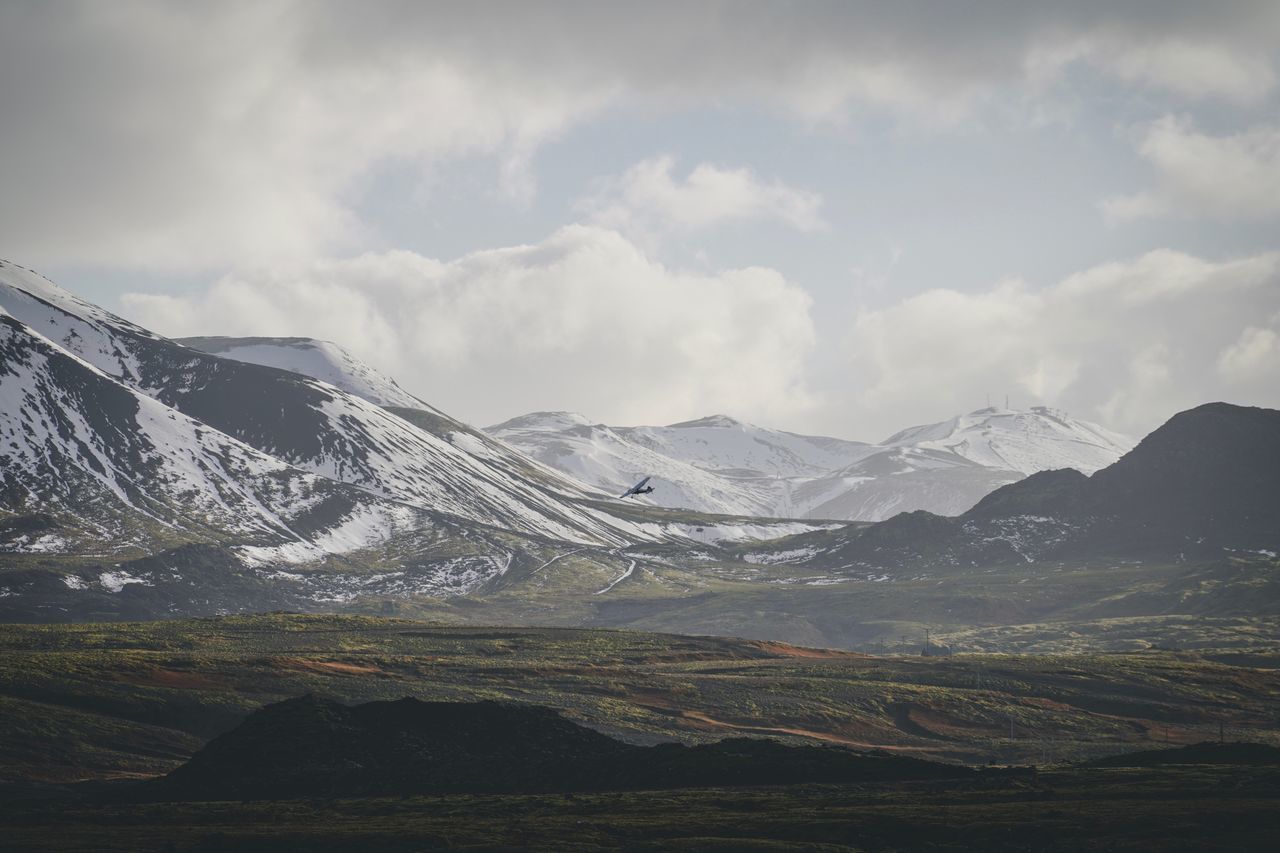 SCENIC VIEW OF MOUNTAINS AGAINST SKY DURING WINTER