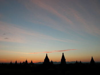 Silhouette temple against sky during sunset