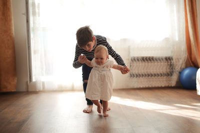 The elder brother cares with the little sister toddler, real interior sincere emotions