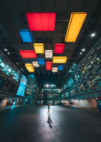 Low angle view of illuminated lights on ceiling at night