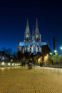 Illuminated building against sky at night