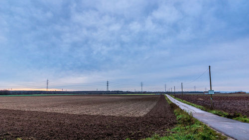 Scenic view of farm against blue sky