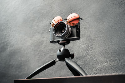 Low angle view of camera with sunglasses on table