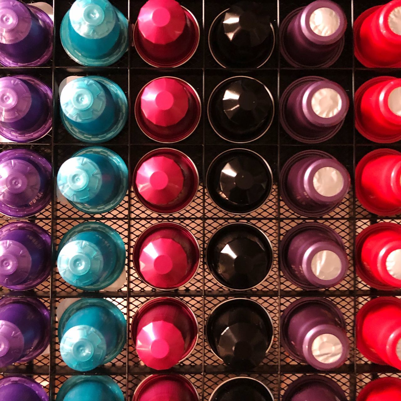 FULL FRAME SHOT OF MULTI COLORED BOTTLES IN CONTAINER