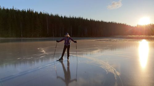 Full length of man standing on lake against sky