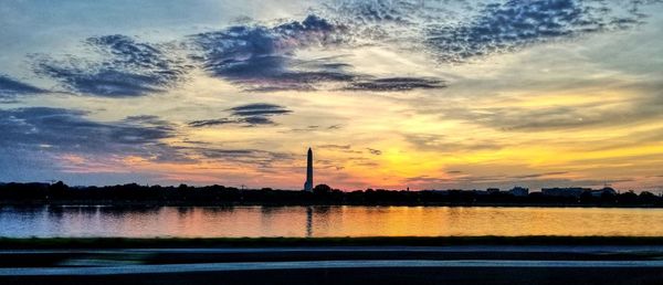 Scenic view of lake against sky during sunset