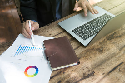 High angle view of man using laptop on table